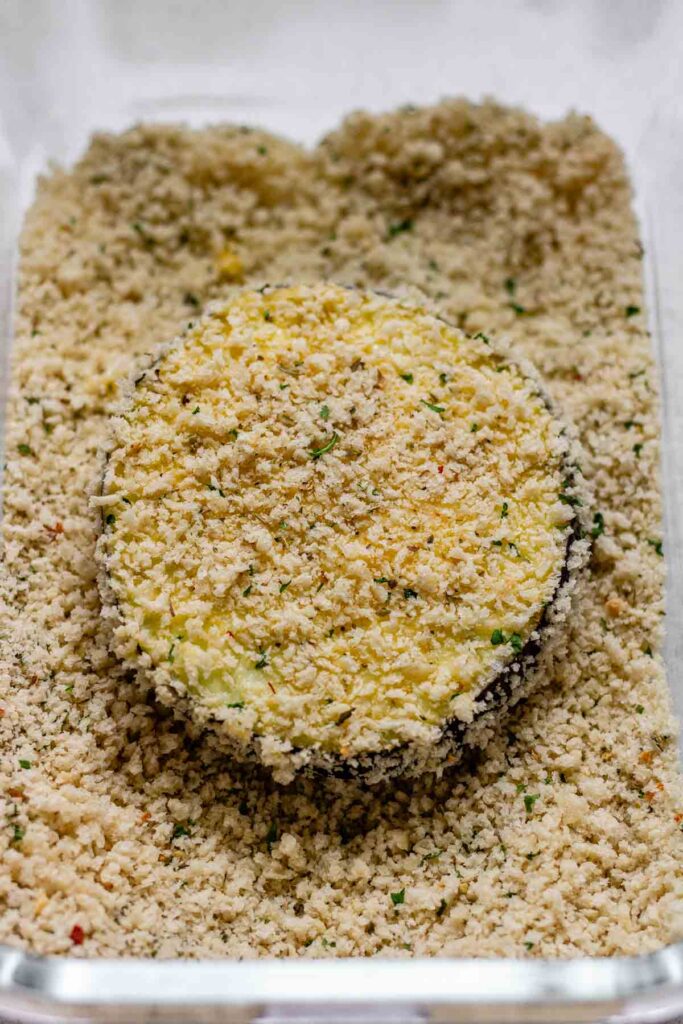 A slice of eggplant coated in breadcrumbs.