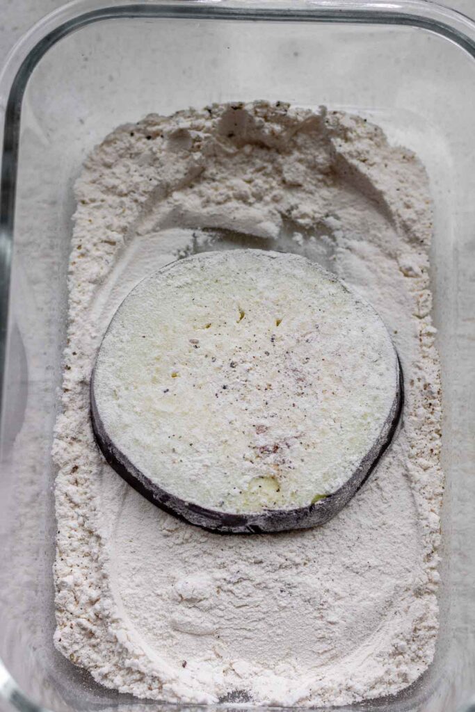 A slice of eggplant coated in flour.