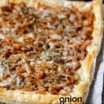 Puff pastry topped with caramelized onions and melted cheese with the text onion puff pastry tart.