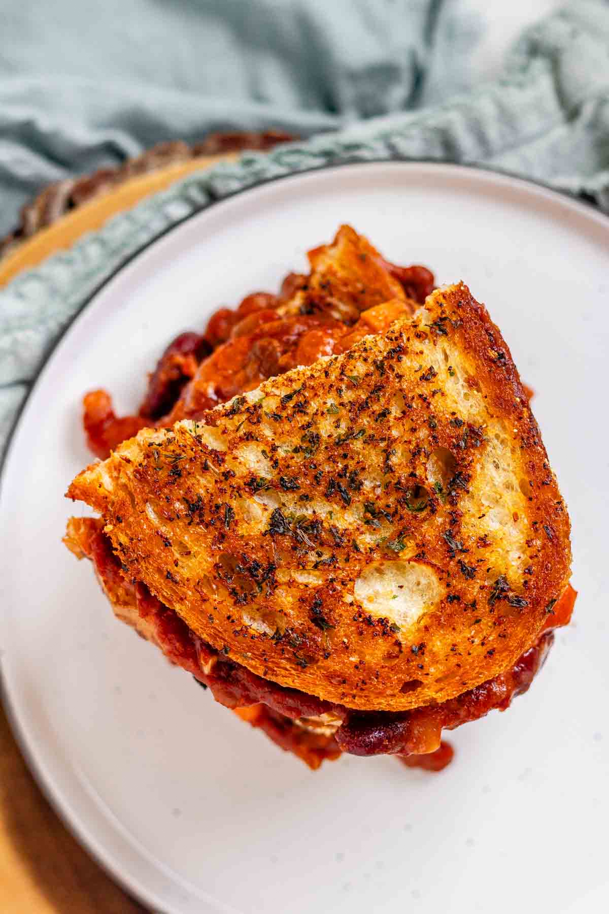 A grilled cheese sandwich with chili oozing out.